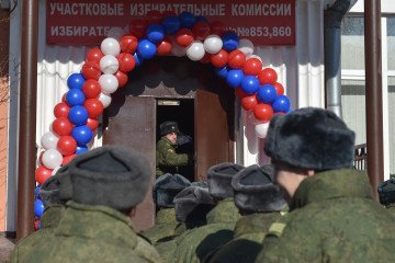 Russian soldiers queue outside a polling station to vote during Russia’s presidential election in Moscow on March 18, 2018. (Source: Getty Images)