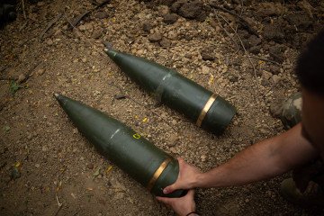 Ukrainian artillery shells are pictured as a squad awaits orders on the left bank of the Dnipro River in Kherson, Ukraine, on August 11, 2025. (Source: Getty Images)