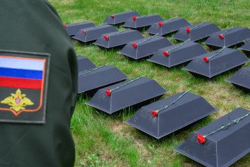 Moscow’s Battlefield Losses Outpace Recruitment by 6,000 Troops a Month A Russian soldier stands beside rows of black coffins. (Source: Getty Images)