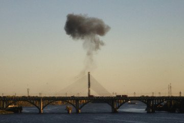 Smoke rises over a bridge spanning the Dnipro River following a drone attack in Kyiv on October 2, 2026. (Source: Getty Images)