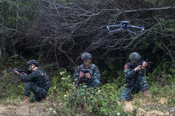 Special forces soldiers use a drone to monitor the environment in Fangchenggang, Guangxi province, China, March 15, 2023.