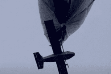 A strike drone hangs beneath a high-altitude tethered aerostat before being released. (Source: Under Fire News)