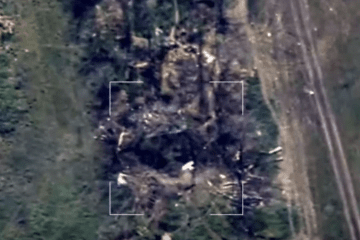 An aerial view from an observation drone captures an incoming strike drone in mid-flight diving directly toward a Russian artillery position along a treeline. (Source: 44th Separate Artillery Brigade) An aerial view from an observation drone captures an incoming strike drone in mid-flight diving directly toward a Russian artillery position along a treeline. (Source: 44th Separate Artillery Brigade)