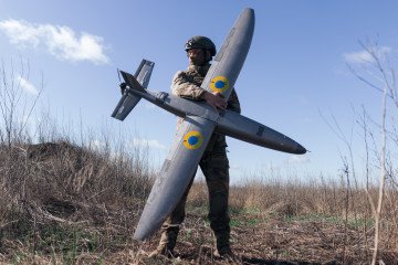 Ukrainian soldier from the “Taifun” UAV unit holds a ‘Marsianin’ attack drone in Kharkiv region, Ukraine, April 7, 2026. (Source: Getty Images)