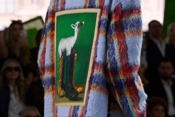 A model walks the runway showcasing a Louis Vuitton creation featuring a print of Nazar Strelyaiev-Nazarko's artwork Paramnesia (2023), where a lamb is depicted wearing luxury boots. (Source: Nazar Strelyaiev-Nazarko's/Instagram)