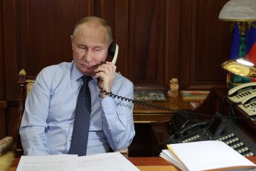 Russian leader Vladimir Putin speaks on a landline phone in Moscow, December 2023—a symbol of the Kremlin’s analog command style in an increasingly digital world. (Photo: Getty Images)