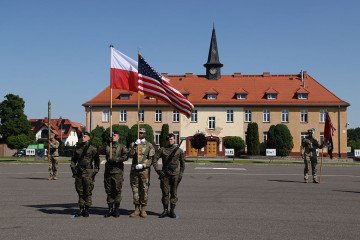 US and Polish soldiers bearing the US and Polish flags lead a Transfer of Authority Ceremony at a Polish military base on June 25, 2026 in Boleslawiec, Poland. (Source: Getty Images)