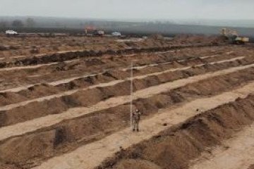 Russian Forces Loot Bronze Age Archaeological Sites Near Occupied Mariupol A worker stands among a vast network of newly constructed earthworks. (Source: Head of the Center for the Study of Occupation)