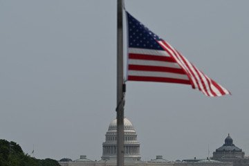 The US Capitol is seen from the National Mall, with flags at half-staff in honor of US Senator Lindsey Graham, who passed away on Saturday, July 11, in Washington, DC, on July 15, 2026.