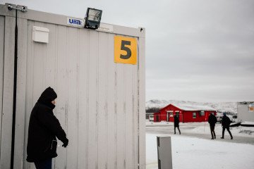 A man smokes a cigarette outside the sleeping facilities at the arrival centre for near the town on Kirkenes in northern Norway close to the border with Russia on November 11, 2015. Illustrative photo. (Source: Getty Images)