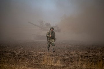 A Russian Army officer walks through dust during military exercises at the Prudboy range in Volgograd region, Russia, on September 24, 2020, during the “Caucasus-2020” military drills. (Source: Getty Images)