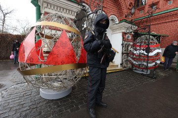 Russian Police officer holds assault riffle next to the figurine of an Easter egg during the service at the Church of the Life-Giving Trinity, on April 11, 2026, in Moscow, Russia. (Source: Getty Images)