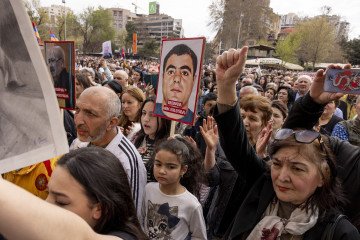 A large crowd of Armenians, including children, raises portraits and fists in unison at a rally in Yerevan, Armenia, on March 29, 2025. Illustrative photo.