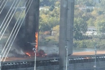 Fire burns near a support of Kyiv’s Pivdennyi Bridge after a reported Shahed-type drone strike on October 1, 2026. (Source: Social media)