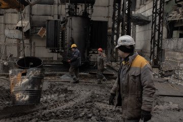 Employees work at a power plant of Ukrainian energy provider DTEK, which was damaged by constant Russian air attacks, at an undisclosed location on November 13, 2025. (Source: Getty Images)