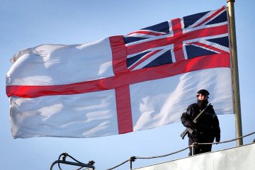 A female sailor patrols the deck of the aircraft carrier HMS Ark Royal as it takes on supplies in Portsmouth. (Source: Getty Images) A female sailor patrols the deck of the aircraft carrier HMS Ark Royal as it takes on supplies in Portsmouth. (Source: Getty Images)