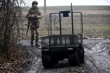 Ukrainian National Guard soldier of the 5th Skif Slobozhanska Brigade operates a domestically produced ground robotic system using a remote control unit, December 11, 2025. (Source: Getty Images)