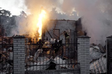 Firefighters extinguish an overturned vehicle that caught fire due to the Russian missile and drone strikes. (Source: Lucile Brizard/UNITED24 Media)