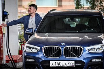 A man fills up his car at a gas station in Moscow on September 8, 2025.