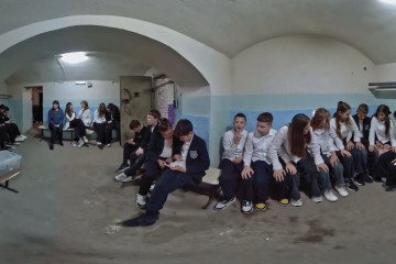 A 360-degree still from the VR documentary “Shelter” immerses viewers inside a basement bomb shelter as schoolchildren wait out an air raid. (Source: Mariia Kravchenko / PR “Shelter”)