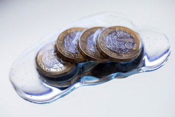 Illustrative image. British one-pound coins sit in hand sanitizing gel in this arranged photograph in Danbury, UK, on March 23, 2020. (Source: Getty Images)