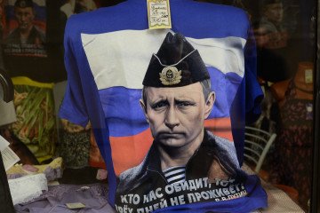 Image of Russian leader Vladimir Putin on a t-shirt displayed in a souvenir shop in Moscow. Image of Russian leader Vladimir Putin on a t-shirt displayed in a souvenir shop in Moscow.