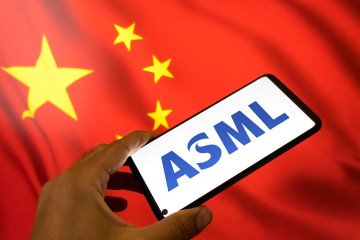 The ASML logo appears on a smartphone screen, and the Chinese flag displays as the background on a laptop computer screen in this photo illustration. (Source: Getty Images) The ASML logo appears on a smartphone screen, and the Chinese flag displays as the background on a laptop computer screen in this photo illustration. (Source: Getty Images)