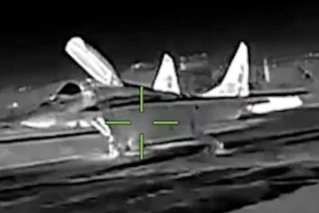 Thermal‑imaging view shows a Russian MiG‑29 fighter jet on the ground moments before being targeted during a Ukrainian intelligence strike in Crimea. (Source: HUR)