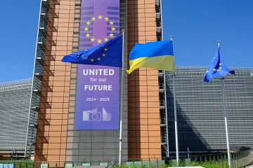 EU and Ukrainian flags fly in the wind in front of the Berlaymont, the EU Commission headquarter for the independance day of Ukraine, on August 24, 2025 in Brussels, Belgium. (Source: Getty Images)