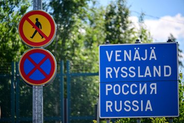A sign reading "Russia" in various languages is posted at a closed border crossing on the Finnish-Russian border, in front of the border fence. illustrative picture. (Source: Getty Images)