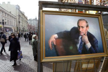 People walk by a painting of Russian President Vladimir Putin, 12 March 04 on Arbat Street in Moscow (Source: Getty Images) People walk by a painting of Russian President Vladimir Putin, 12 March 04 on Arbat Street in Moscow (Source: Getty Images)