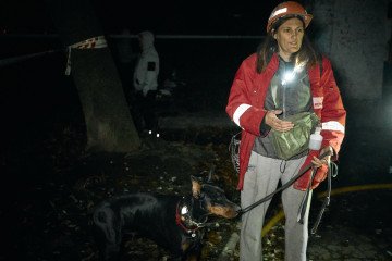 A rescue worker and her search dog operate through the darkness in Kyiv after Russia’s overnight strike on November 14, 2025. (Source: Joshua Olley/UNITED24 Media)
