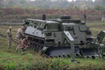 Ukrainian soldiers stand near armoured recovery vehicle Wisent 1 during training of engineer troops on October 6, 2025 in Ukraine. (Source: Getty Images)