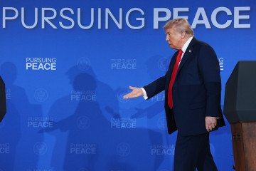 US President Donald Trump reaches out to shake hands with Russian leader Vladimir Putin at the end of a press conference at Joint Base Elmendorf-Richardson on August 15, 2025, in Anchorage, Alaska. (Source: Getty Images)
