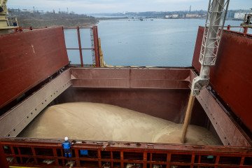 Grain is loaded into a ship's cargo hold at a port terminal. (Source: Getty Images)