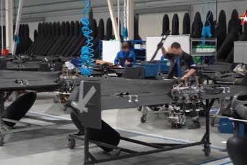 Drone propulsion systems are installed during final assembly, with mechanical components visible beneath the fuselage. (Source: Zvezda TV)