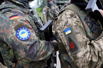 A German and a Ukrainian soldier stand shoulder to shoulder in Mecklenburg-Western Pomerania, May 29, 2024. (Source: Getty Images)