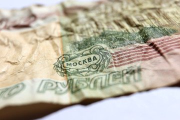 The Russian words for ruble and Moscow can be read on a 100 ruble banknote. (Source: Getty Images)