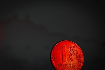 A Russian ruble coin, illuminated in red, sits in front of a screen displaying a stock chart, in this illustration picture taken on October 6, 2023 in Moscow. A Russian ruble coin, illuminated in red, sits in front of a screen displaying a stock chart, in this illustration picture taken on October 6, 2023 in Moscow.