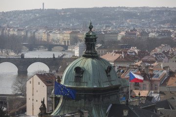 Westward views from Letna Park to the district of Hradcany and the Charles Bridge on the Vltava river where the EU and Czech flags fly over a government building. (Source: Getty Images)