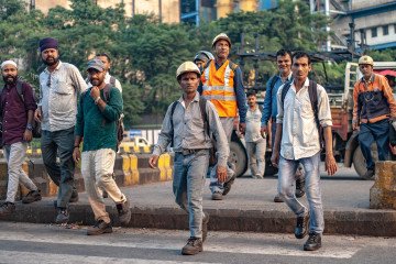 Workers pass by Tata Steel Ltd. plant in Jamshedpur, highlighting daily operations at one of the company's key production sites. (Source: Getty Images)