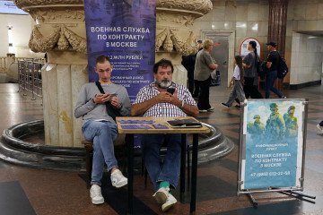 Campaigners at the recruitment center for contract military service in the war with Ukraine sit in the metro station lobby, on July 23, 2026, in Moscow, Russia. (Source: Getty Images)