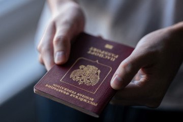 Russia and Iran Among 75 Countries Affected by US Visa Freeze in Immigration Crackdown Konstantin, 26 years old from Russia, holds his passport during an interview with AFP in Belgrade on February 1, 2024. Illustrative image. (Photo: Andrej Iskovic/AFP via Getty Images)