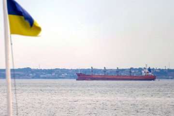 Ukrainian flag waves near cargo ship in Black Sea. (Source: Getty Images)
