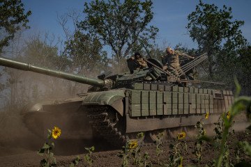 Ukrainian soldiers ride their tank in the Kherson region, Ukraine, on August 8, 2025. (Source: Getty Images)