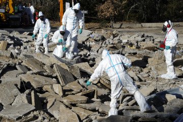 Firefighters conduct acoustic analysis in wreckage during a simulation exercise combining a nuclear accident and an earthquake at the Cadarache nuclear research center (CEA) in France. (Source: Getty Images)