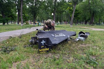 A Ukrainian explosives expert examines parts of a Shahed 136 military drone that fell following an air-attack in Kharkiv on June 4, 2025. (Source: Getty Images)