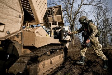 Australia Pledges Additional $100M in Military Aid to Ukraine for Critical Defense Support A demining operator of the 808th Dniester Separate Support Brigade of the Armed Forces of Ukraine works beside a GCS-200 mechanical demining machine in Kherson region, Ukraine, on November 22, 2025. (Source: Getty Images)
