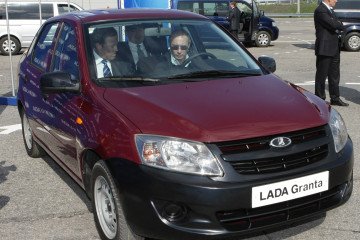 Russian leader Vladimir Putin (R) drives a new model of Russian Lada-Granta car during his visit to “AvtoVaz” automobile plant in Togliatti on May 11, 2011. (Source: Getty Images)