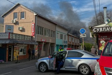 Russian police officers secure an area as smoke rises following a recent drone attack on the Tuapse oil refinery in Tuapse, Krasnodar region on April 29, 2026. (Source: Getty Images)
